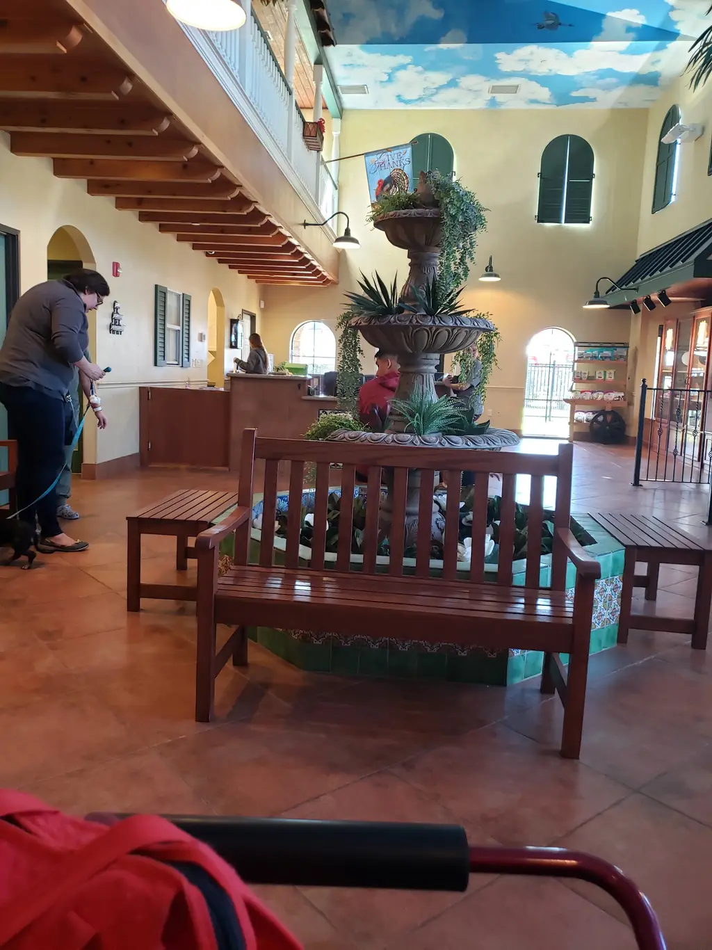 The two storey courtyard lobby at Rose-Rich, with Talavera tile, palm trees and a central fountain